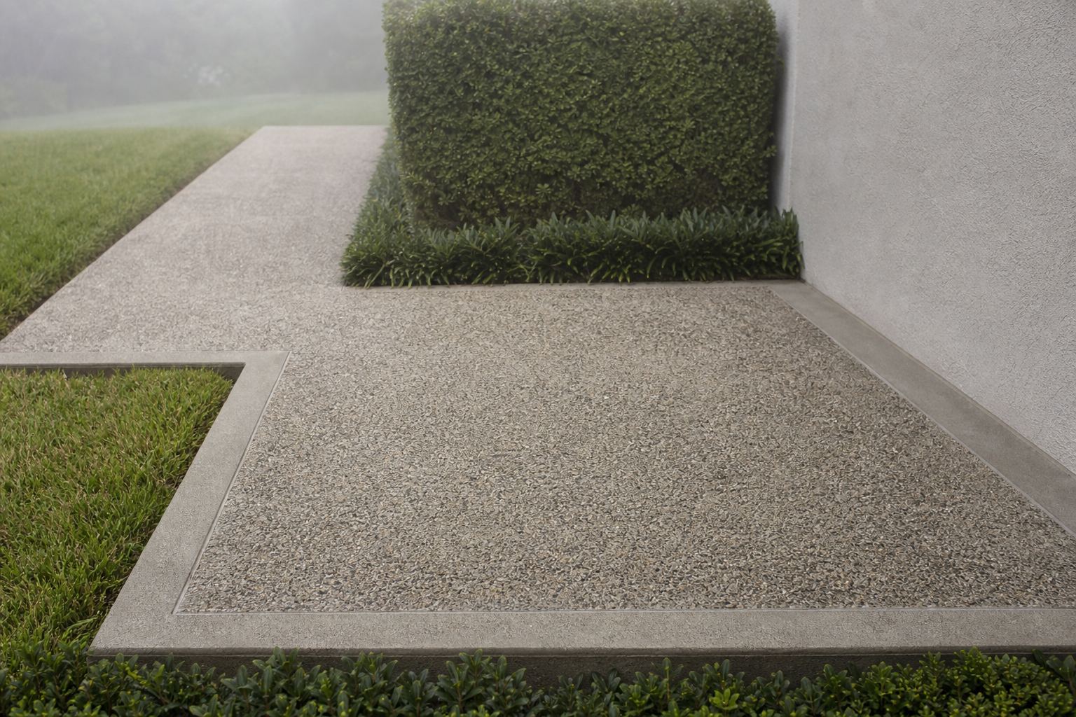 Close view of an exposed-aggregate landing and turning walkway